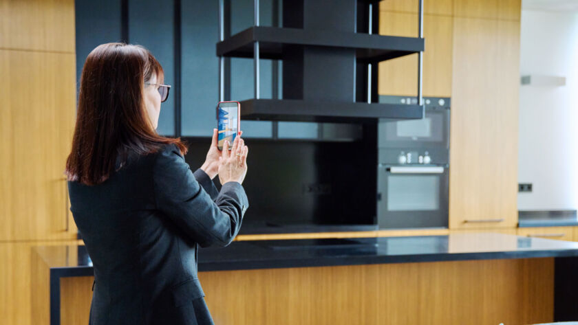 Real estate agent creating Instagram content for a stylish open concept interior to attract serious buyers.