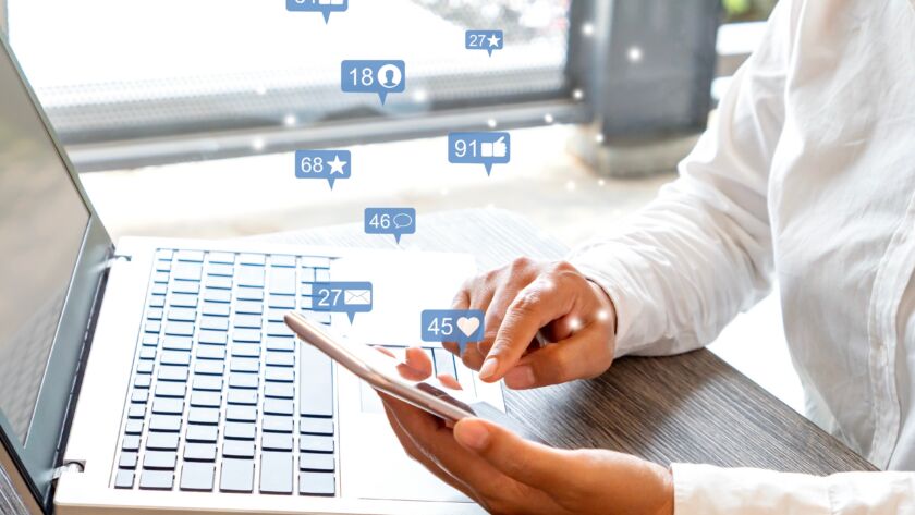 realtor analyzing sample real estate facebook ads on a laptop