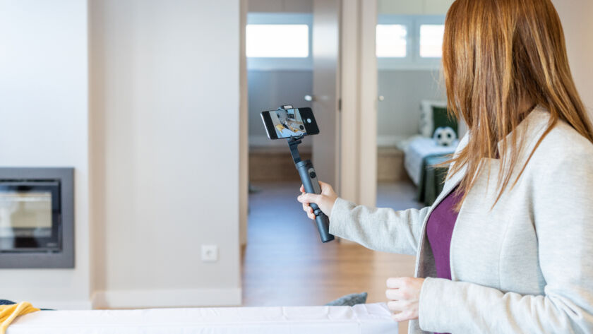 Video marketing for real estate agents filming a listing walkthrough on a smartphone